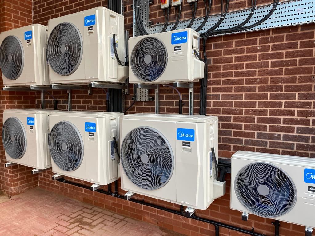 Air conditioning condensers mounted on a brick wall